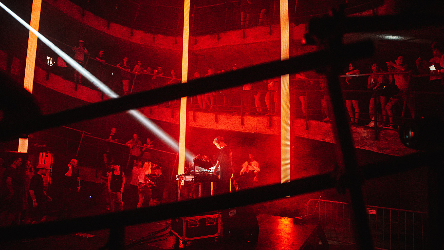 DJ S13 performing beneath red light at Audra Festival in Kaunas
