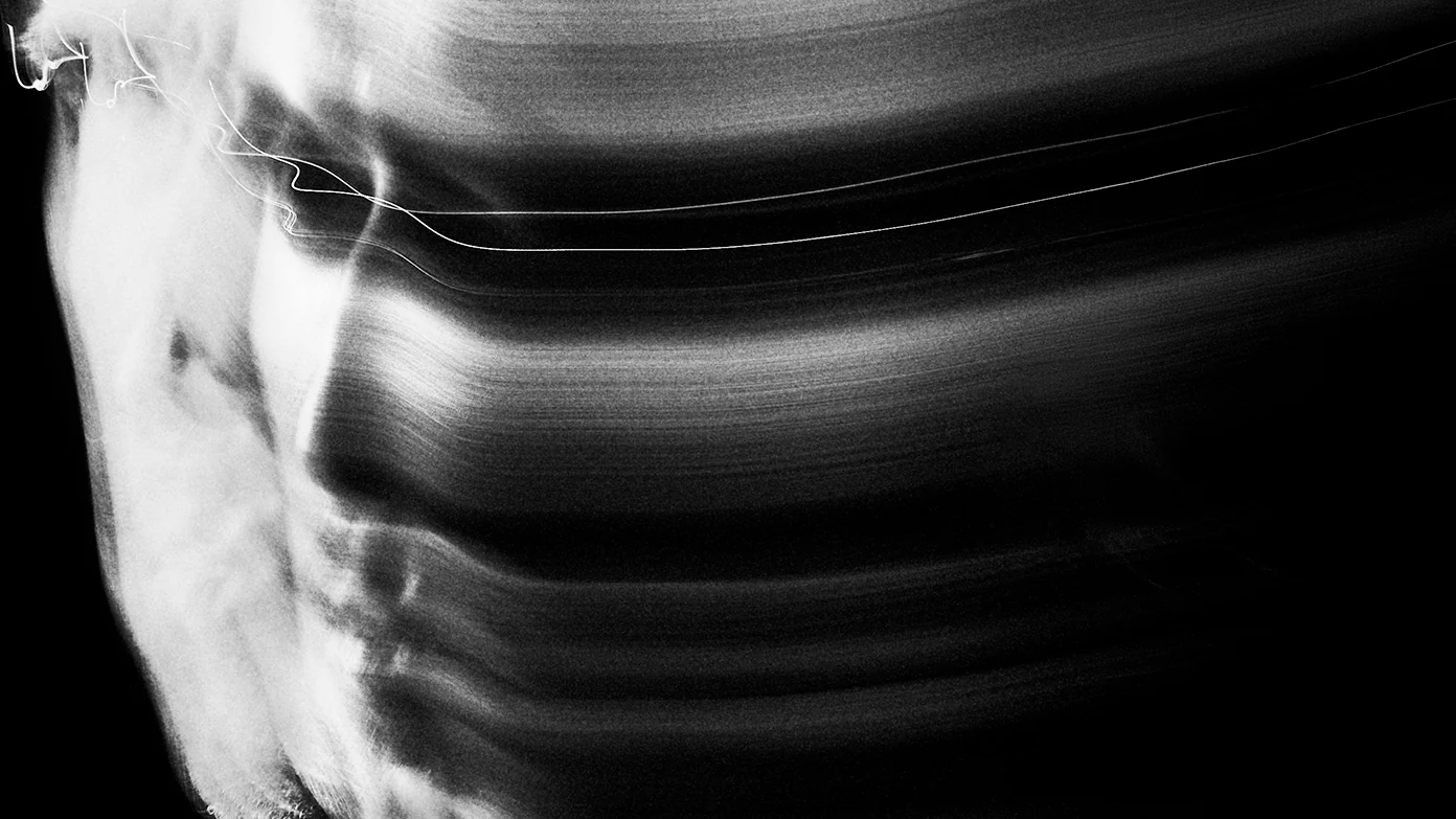 TRSSX — a long-exposure portrait with blurred light trails.