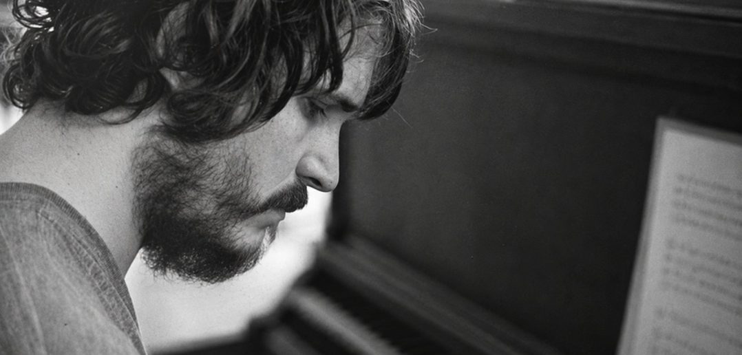 Rafael Anton Irisarri in profile beside a piano, photographed by Sean Curtis Patrick