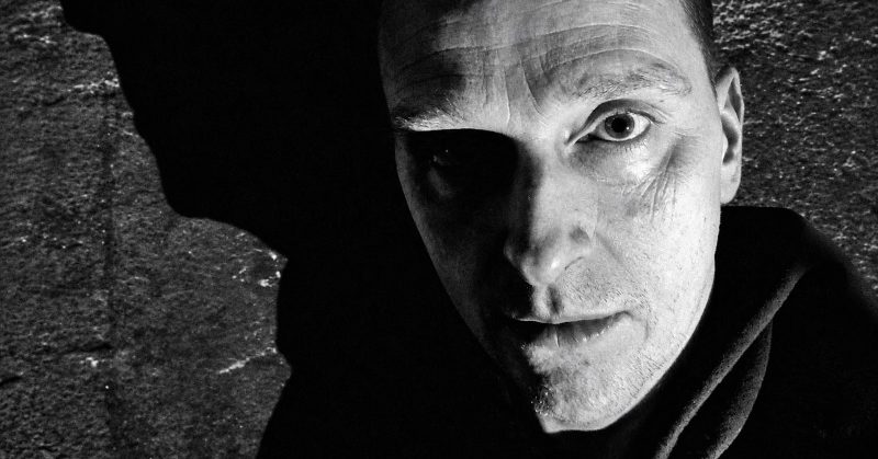 Black-and-white portrait of Justin K. Broadrick, recording as JK Flesh.