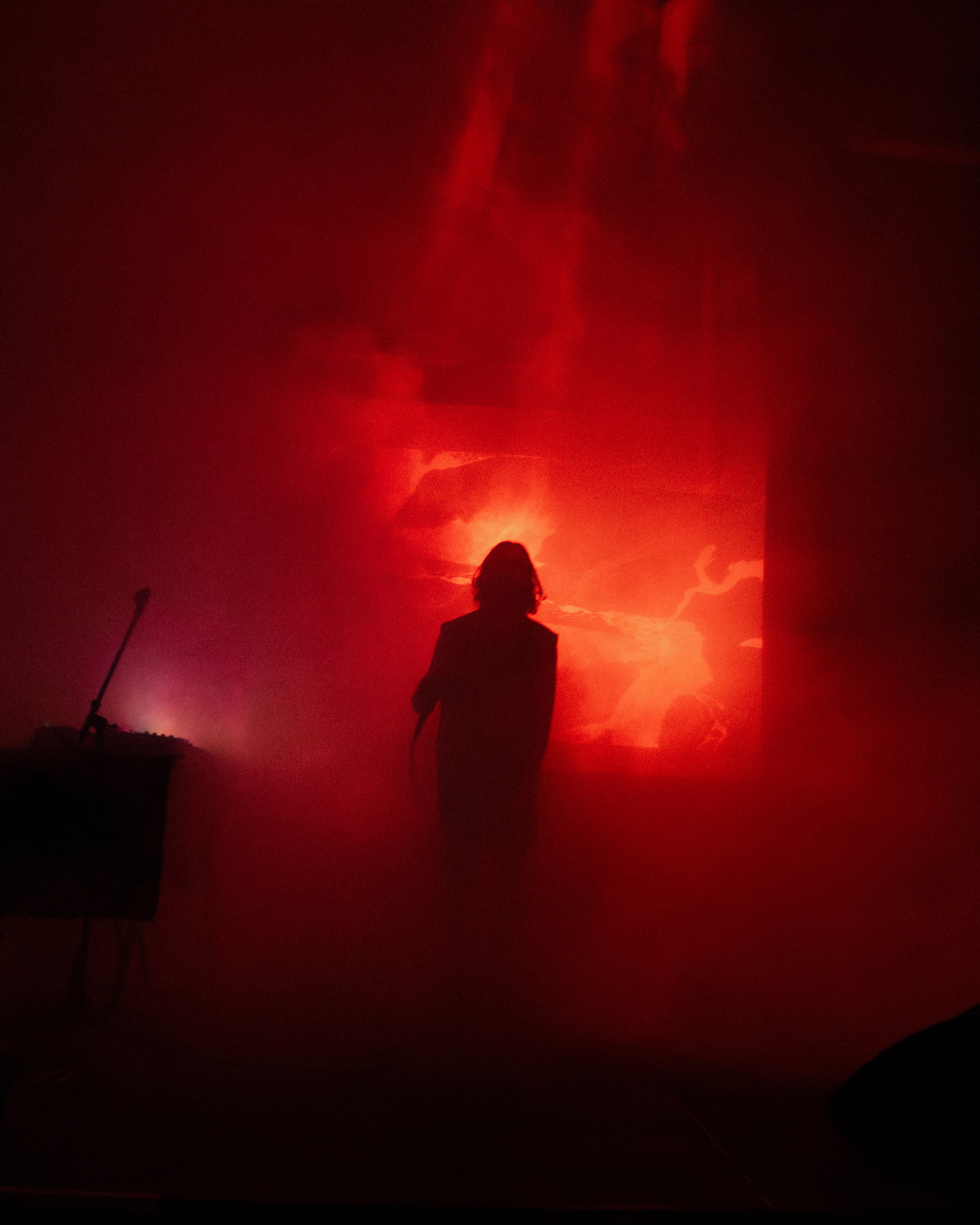 Vertical view of OTTOMAN GRÜW silhouetted beneath glowing red projections.