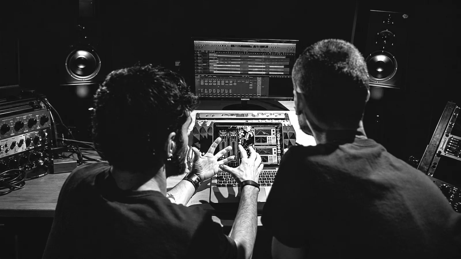 Daniele Antezza and Marco Donnarumma of Dadub working together at a studio desk.