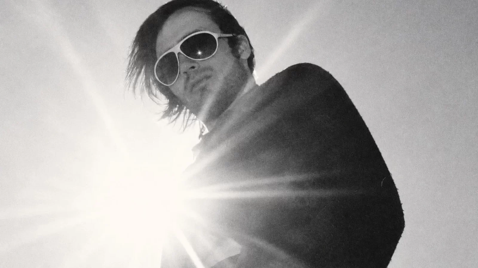 Daniel O’Sullivan in sunglasses in a high-contrast black-and-white photograph.