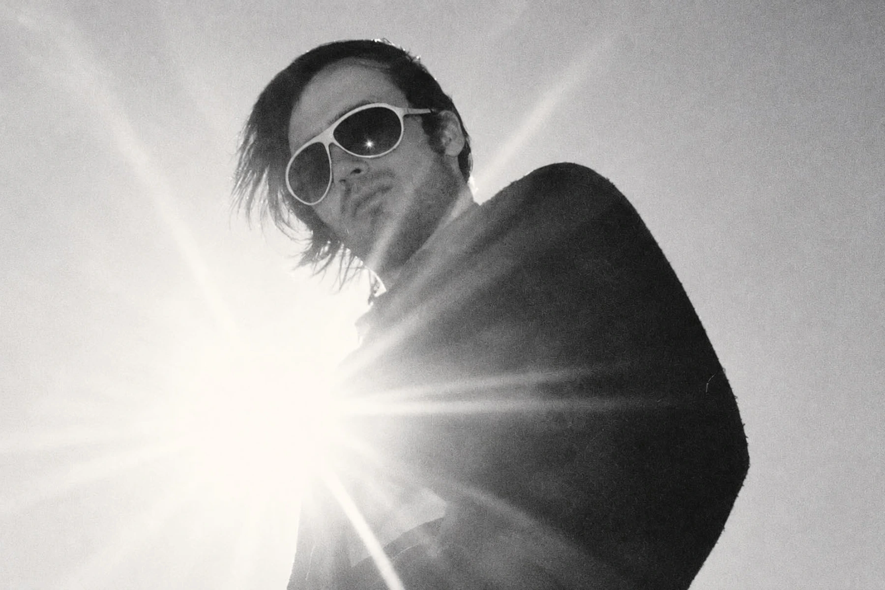 Daniel O’Sullivan in sunglasses in a high-contrast black-and-white photograph.