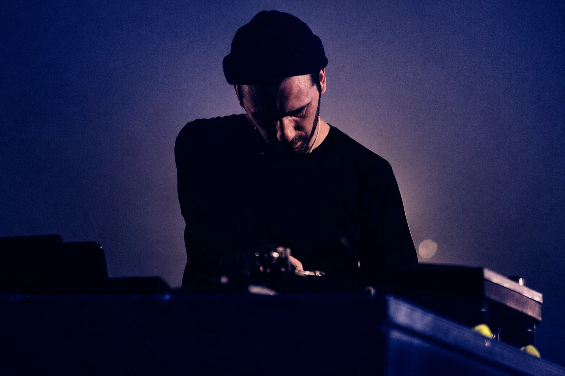 Jay Glass Dubs performing under cool blue stage light.