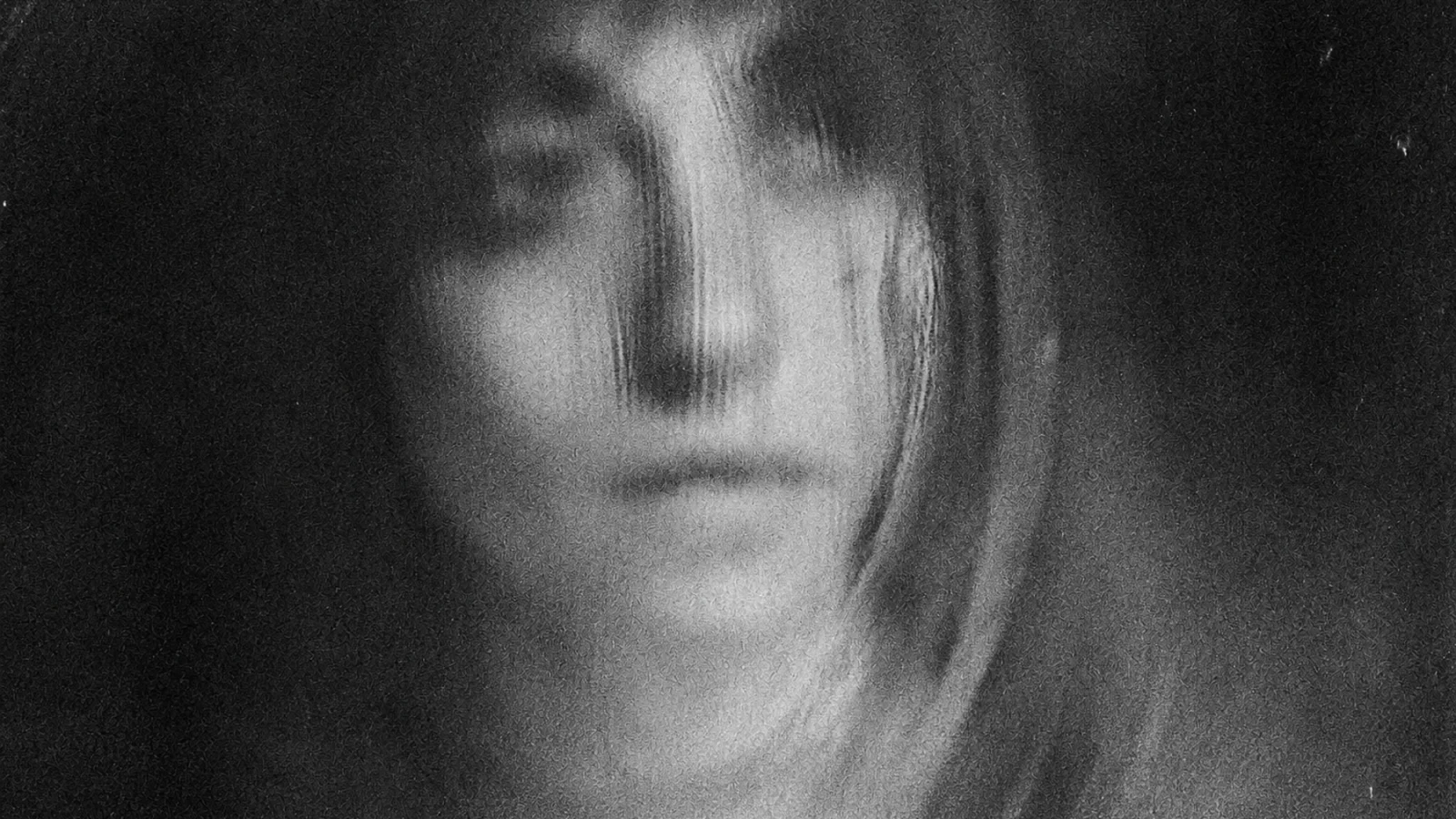 Eva Geist in an intentionally blurred monochrome portrait.