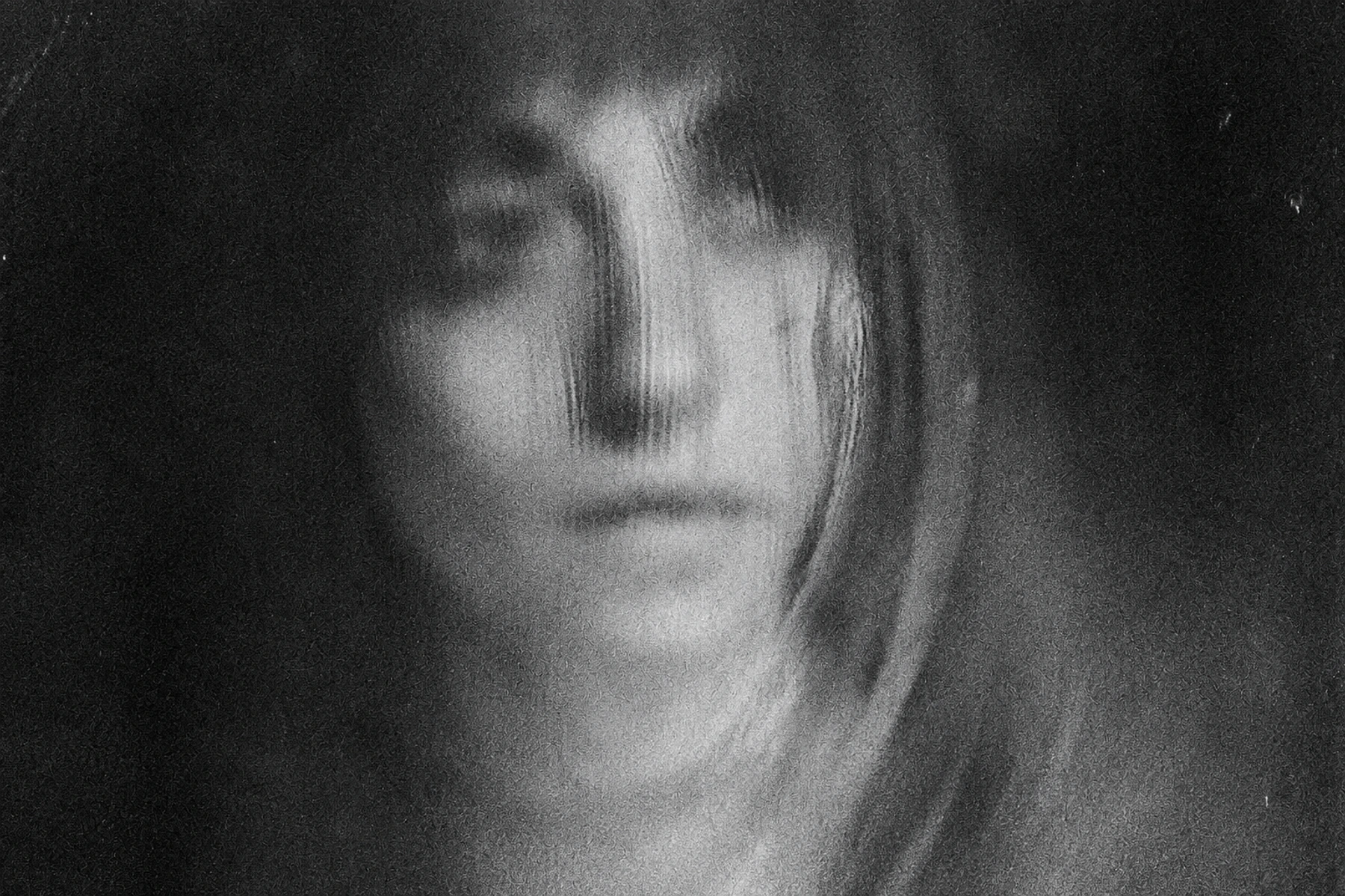 Eva Geist in an intentionally blurred monochrome portrait.