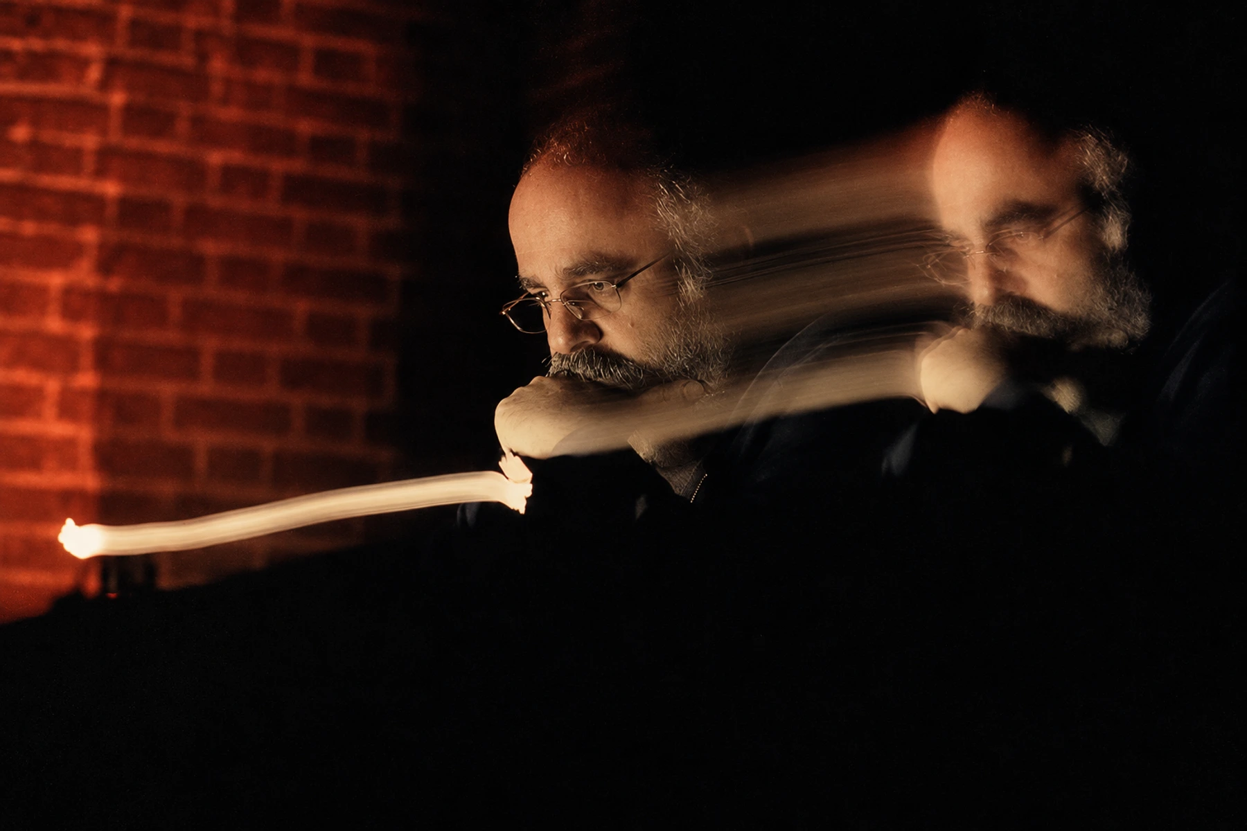Sote in a double-exposure portrait with trails of light.