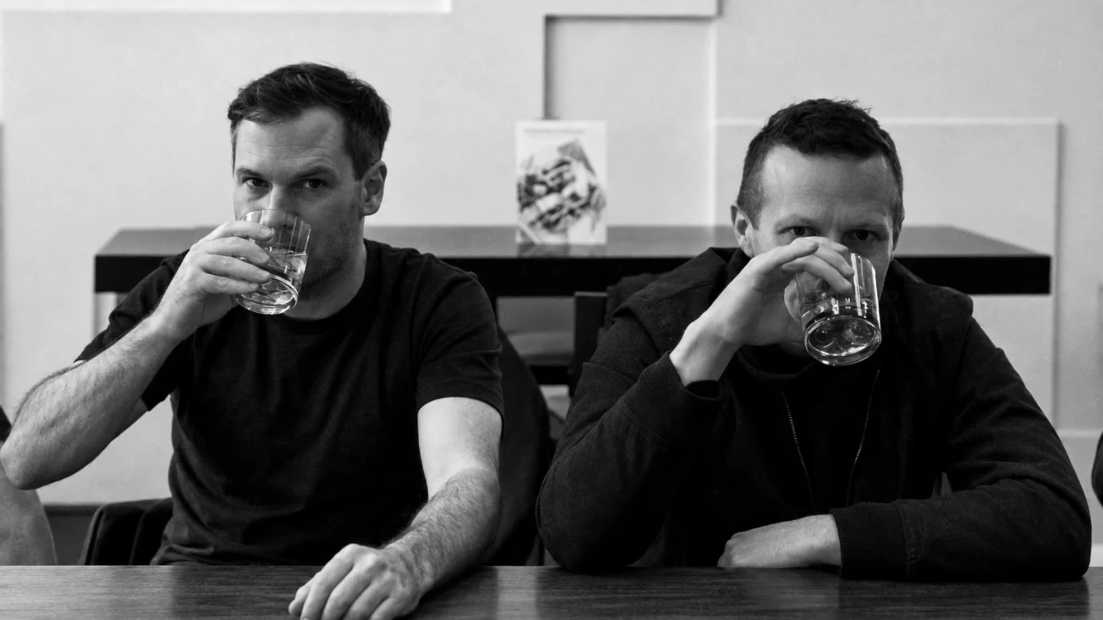 Emil Amos and Alex Hall of Grails holding glasses at a table.