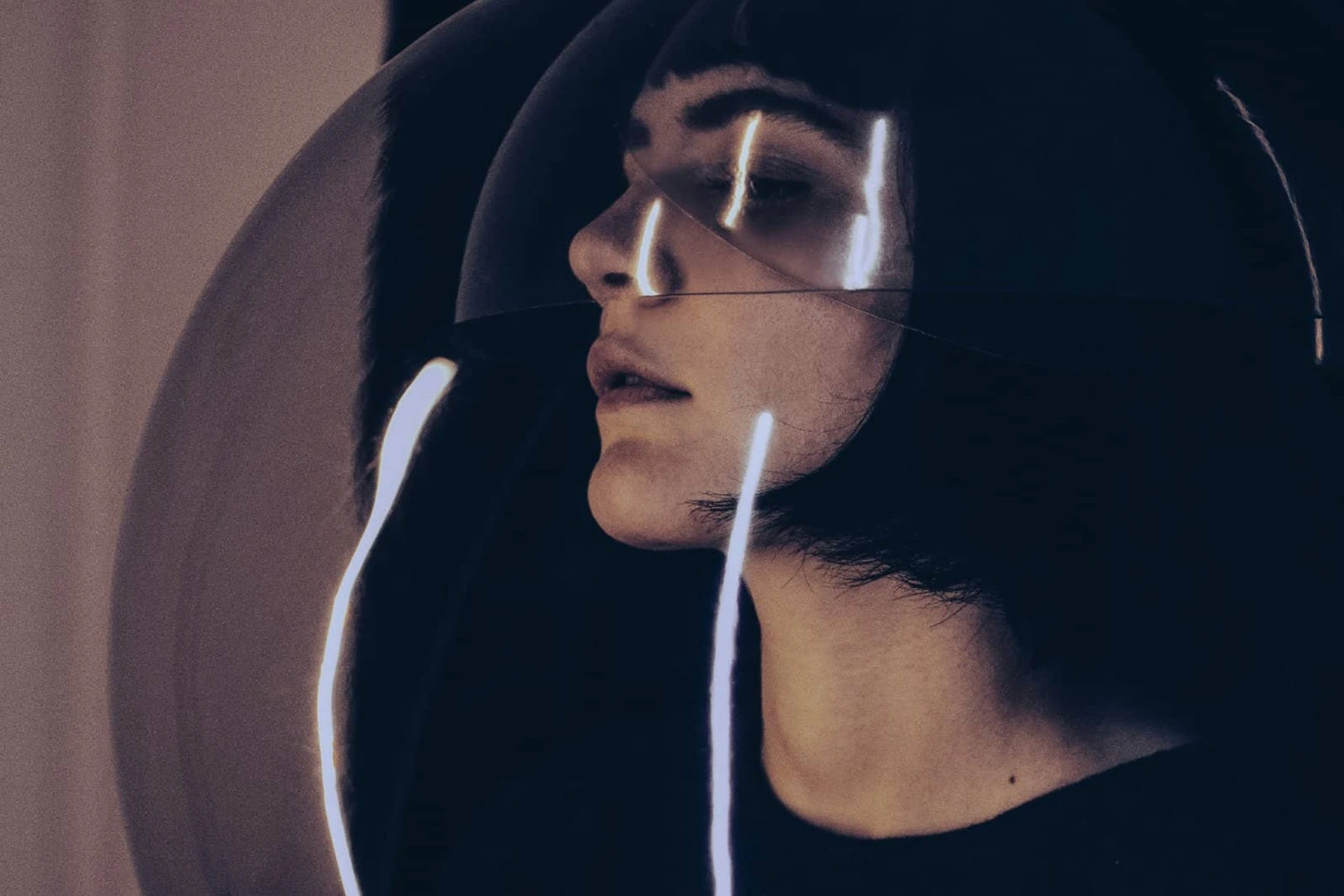 Silvia Kastel seen through overlapping reflected bubbles.