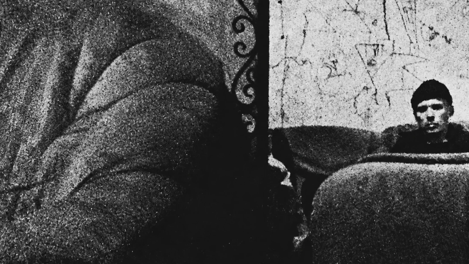 Sstrom seen at the edge of a heavily textured, abstract black-and-white photograph.