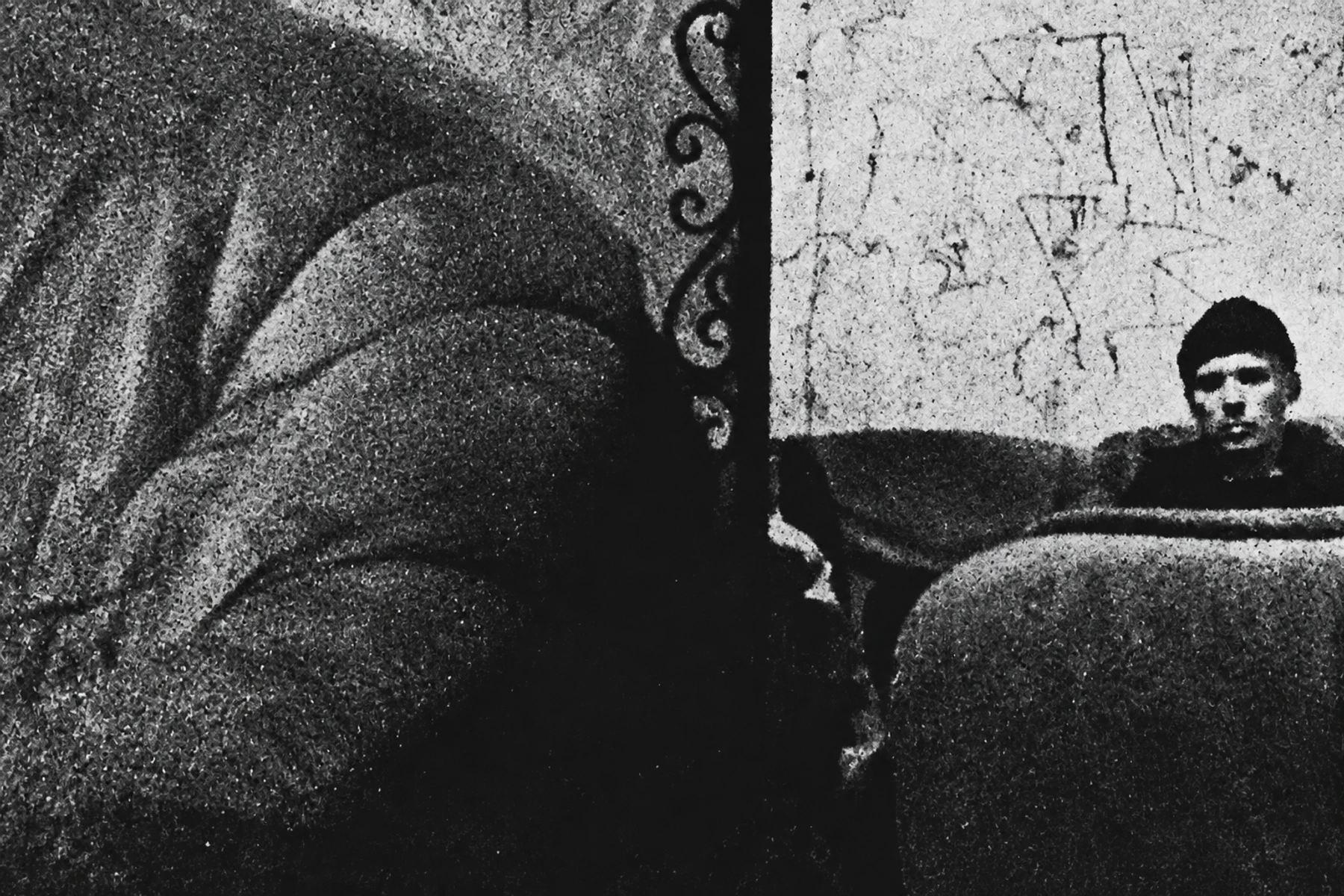 Sstrom seen at the edge of a heavily textured, abstract black-and-white photograph.