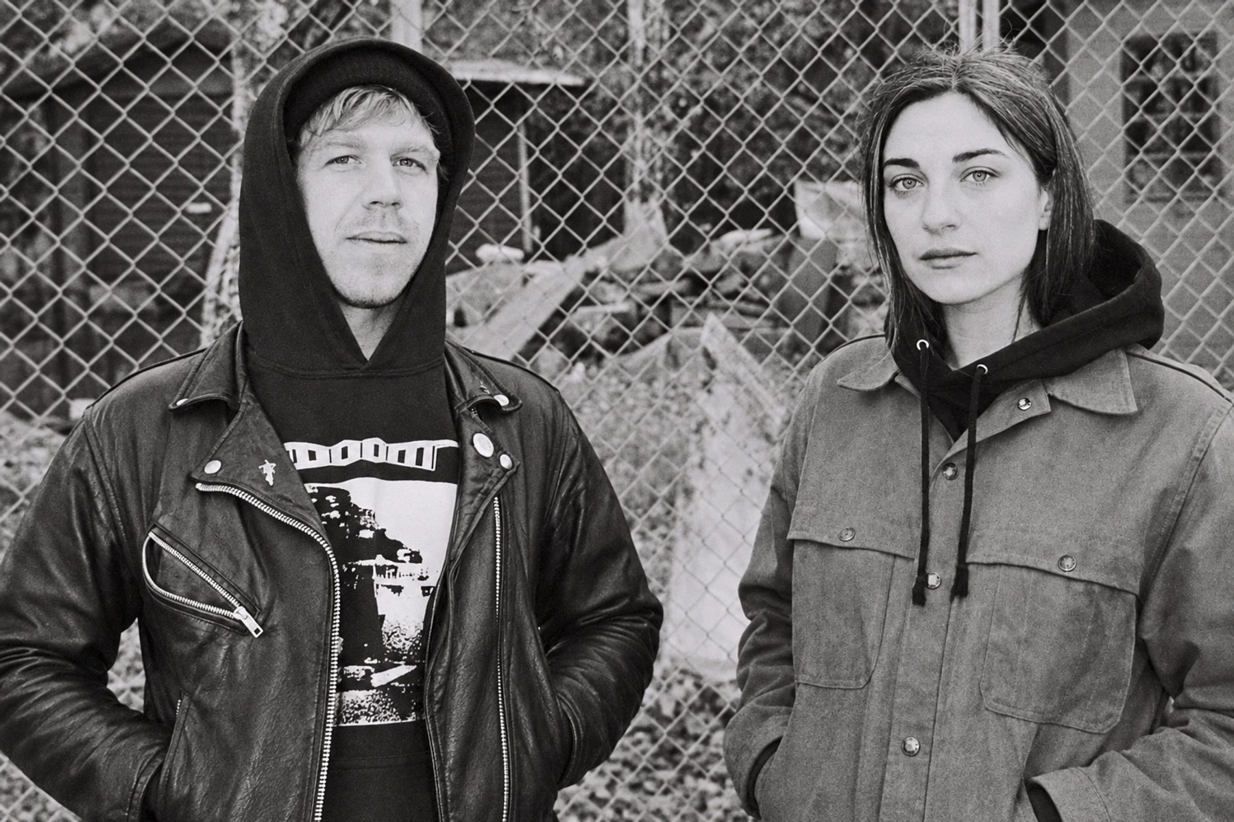 A.M. Rehm and Kali Malone / Sorrowing Christ standing before a chain-link fence.