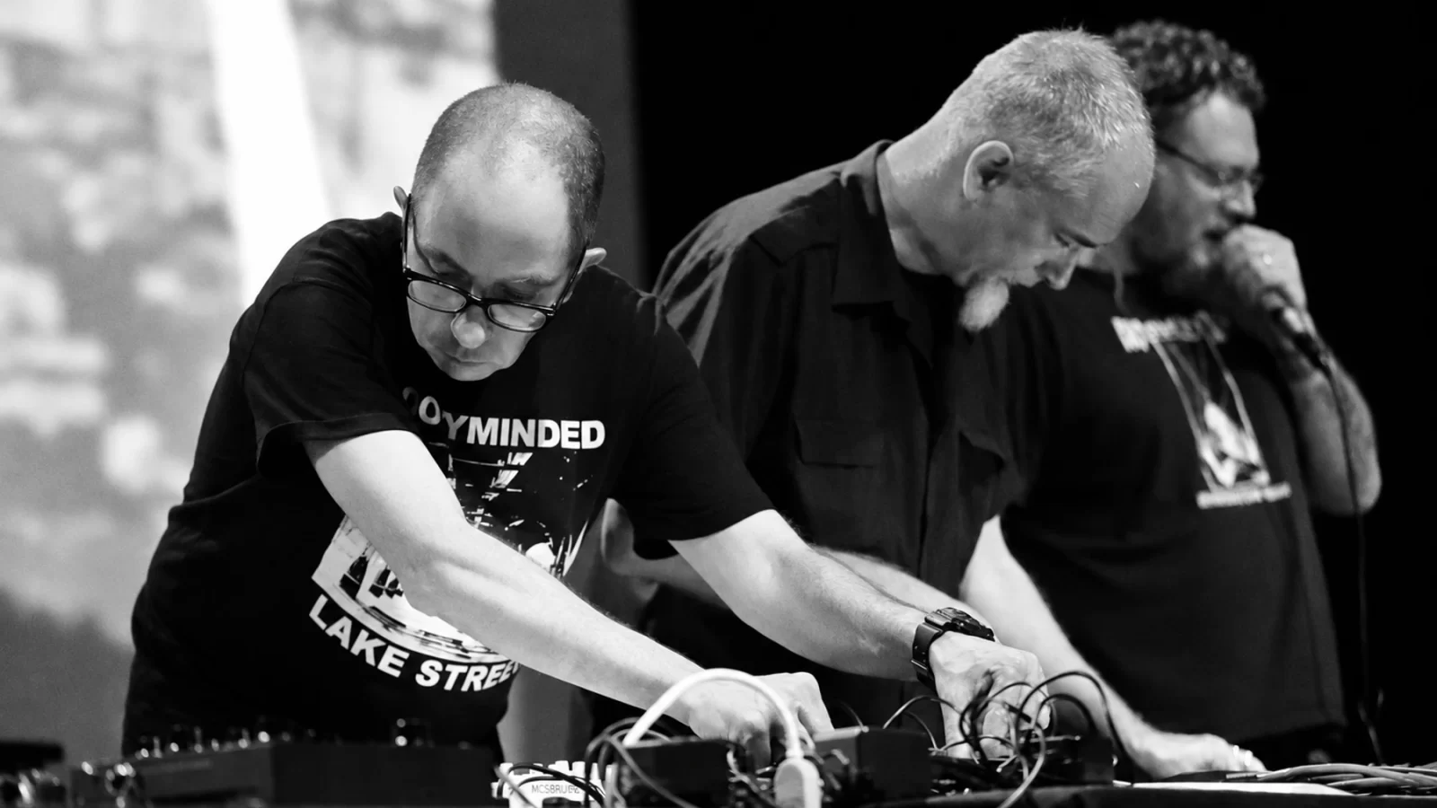 Three Sigillum S performers working with electronics on stage.