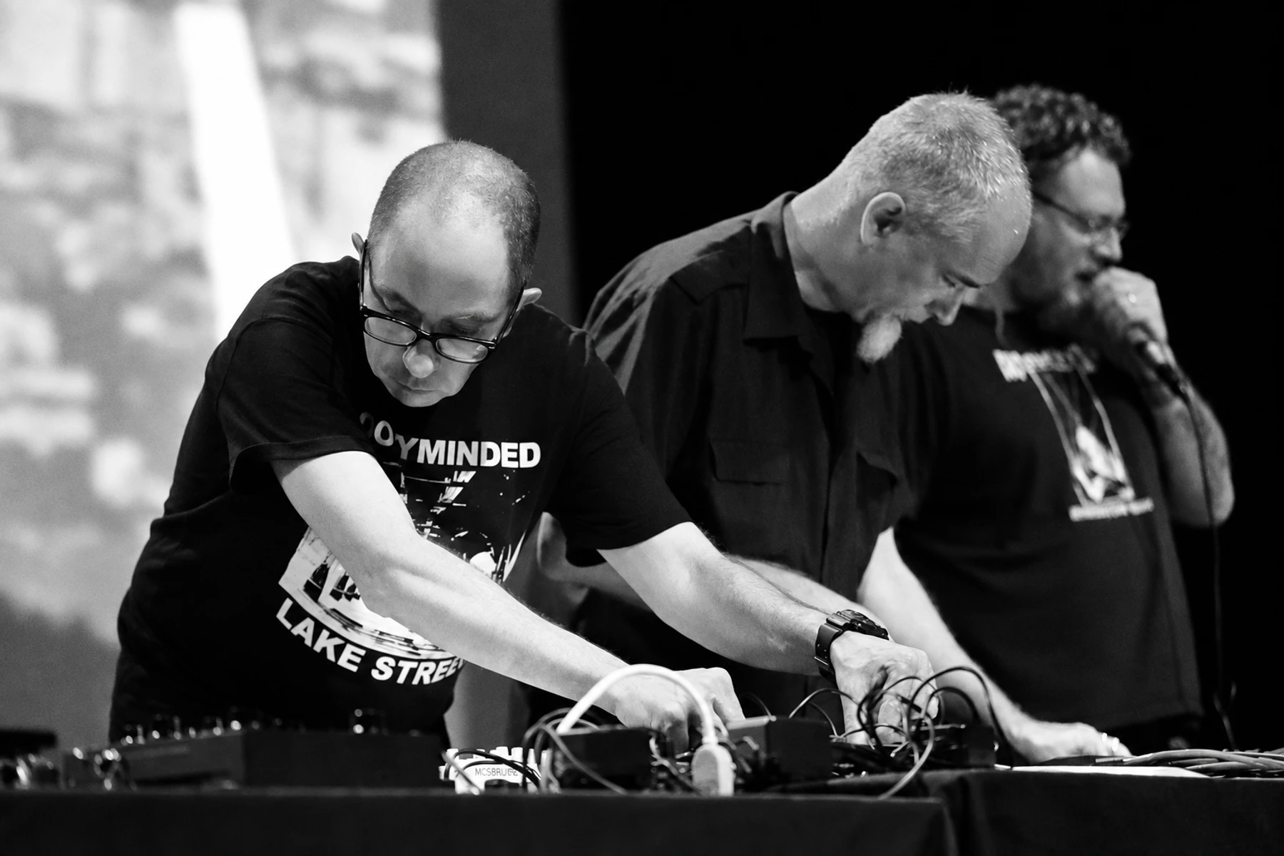 Three Sigillum S performers working with electronics on stage.
