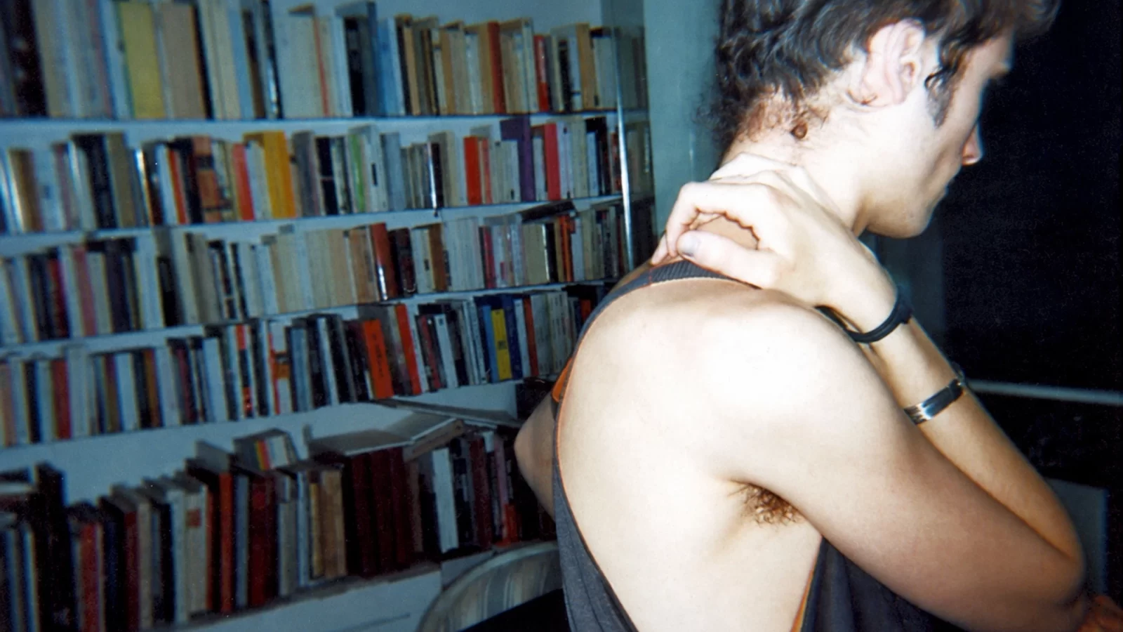Geoffroy C. Dedenis / Cumpire in profile beside shelves of records.