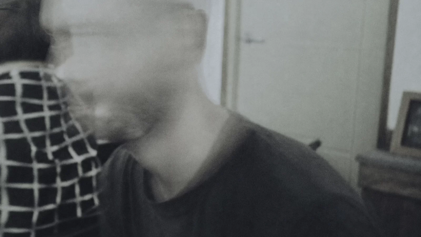 Kumanthong in a deliberately blurred grey-toned portrait.