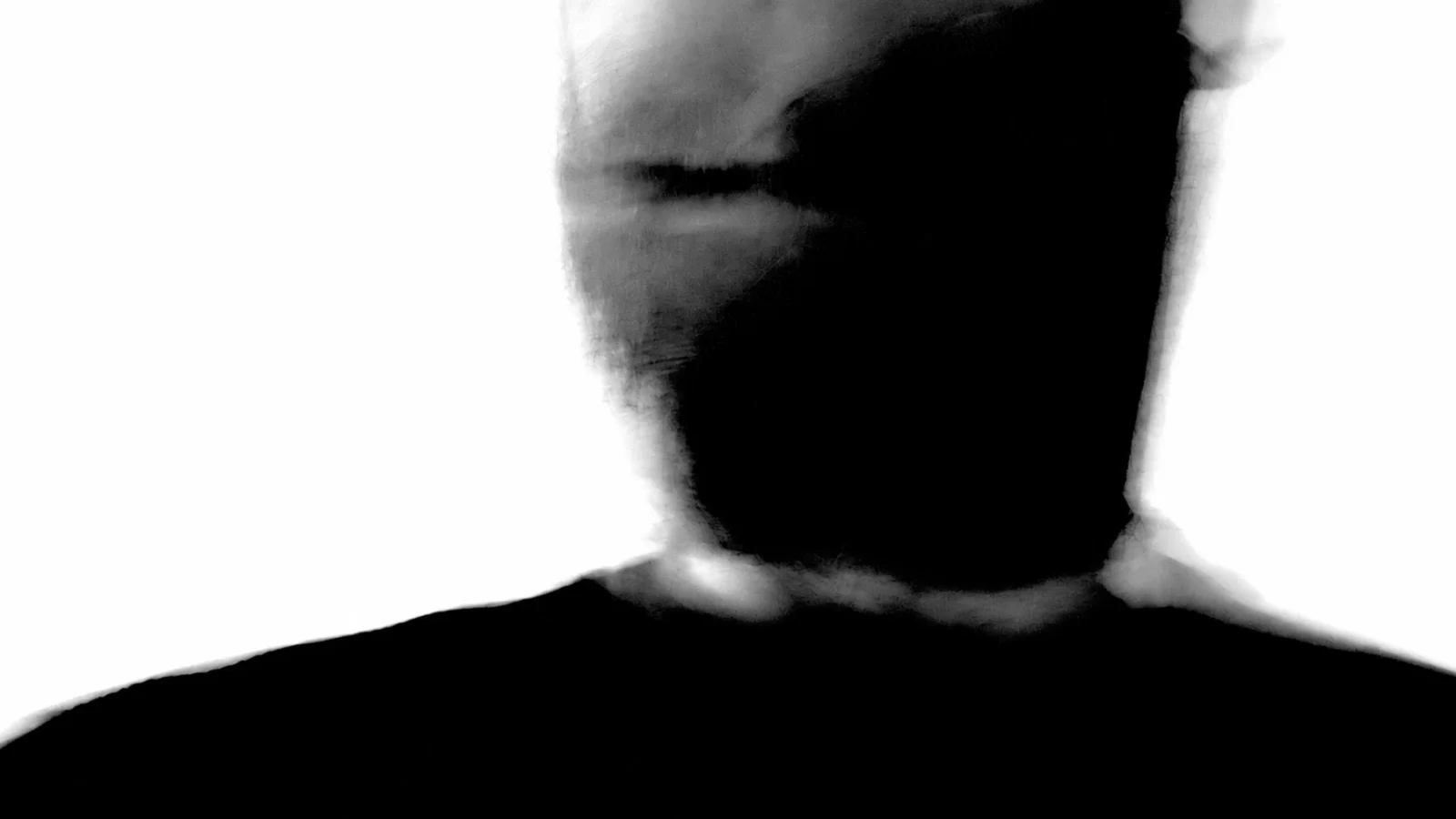 Andrew Bowen / Slave To Society in an intentionally blurred, high-contrast black-and-white portrait.