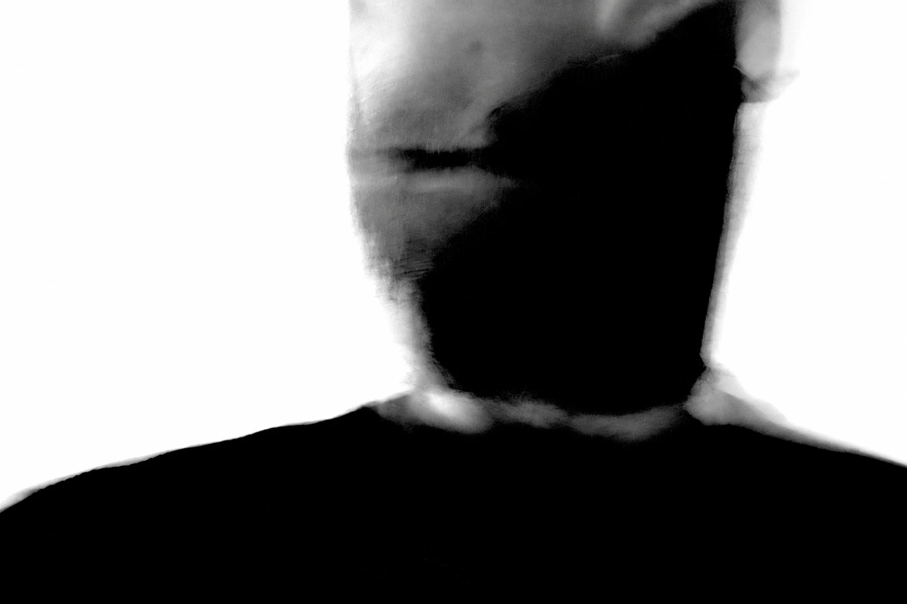 Andrew Bowen / Slave To Society in an intentionally blurred, high-contrast black-and-white portrait.
