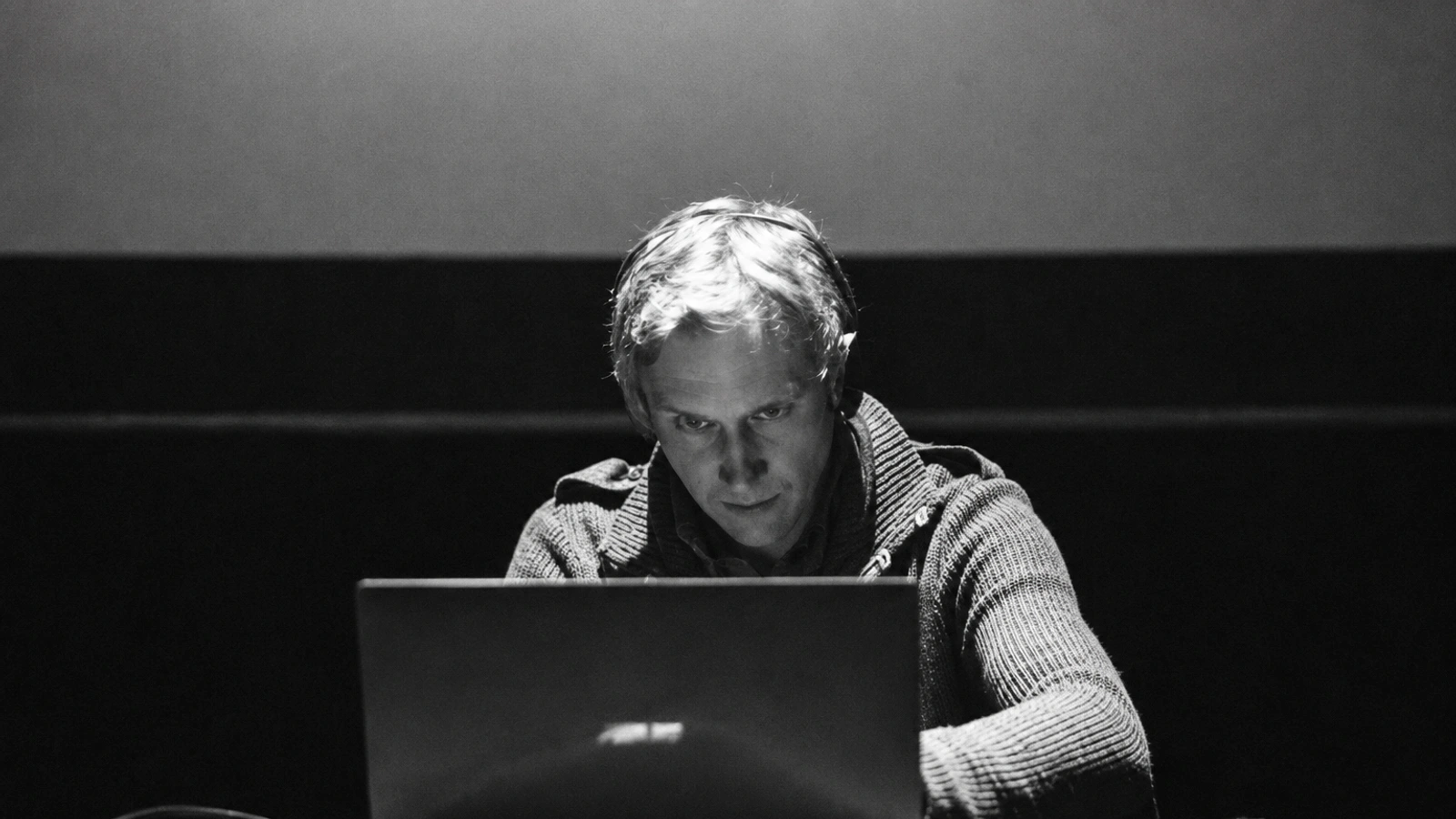 Marcus Fjellström working behind a laptop in a monochrome live portrait.