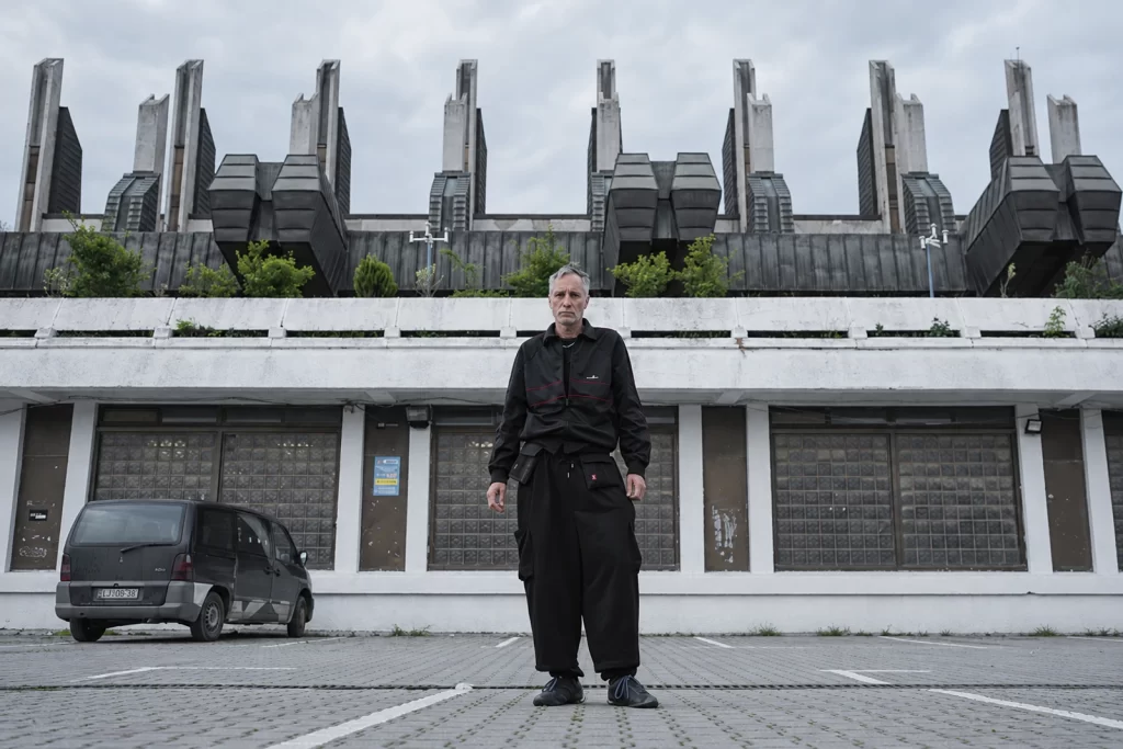 Ran Slavin standing in front of a geometric concrete building.