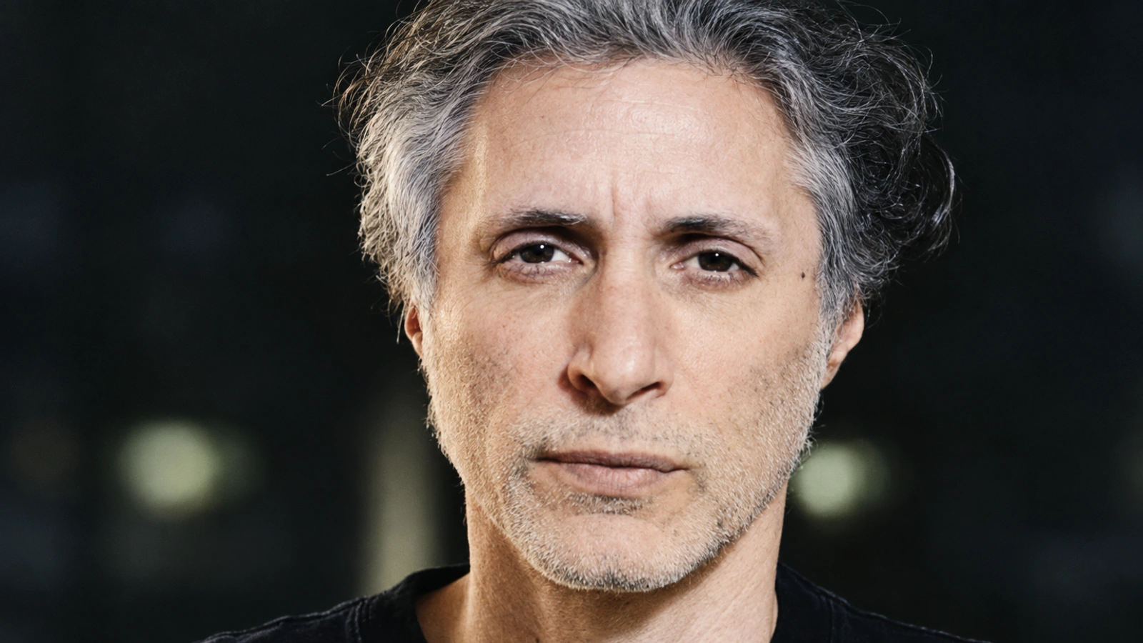 Ran Slavin in a restrained close-up portrait with neutral tones and fine film grain.