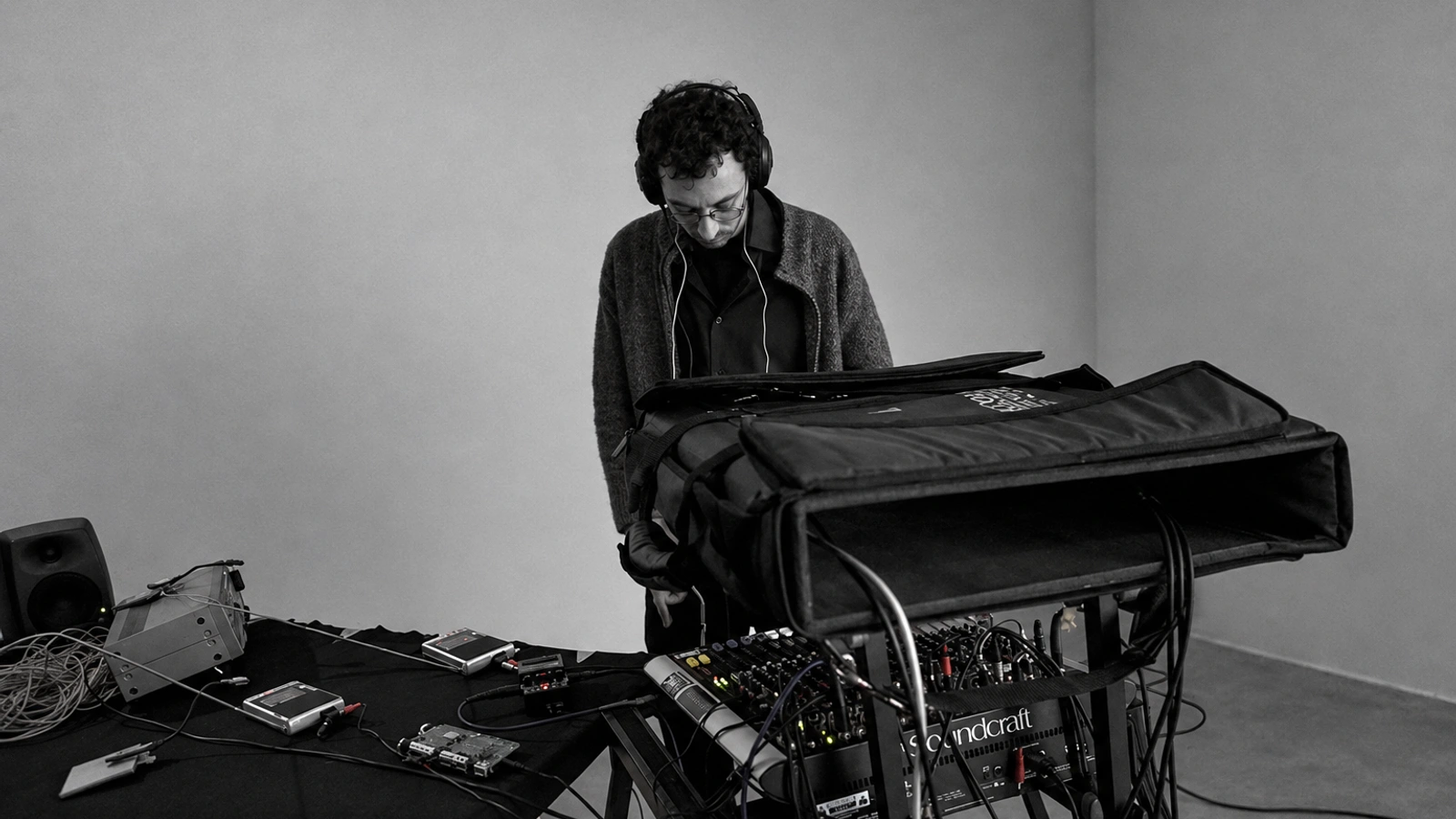 Pietro Riparbelli concentrating on an electronic performance, framed behind his equipment in restrained monochrome.