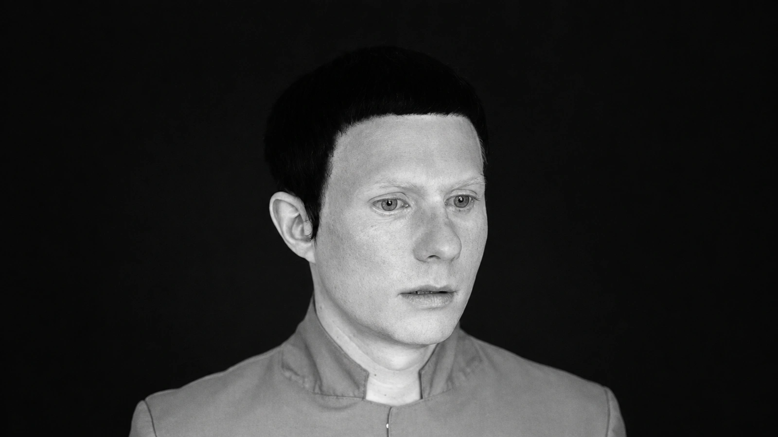 Felix Kubin in a monochrome portrait wearing a mandarin-collar jacket.