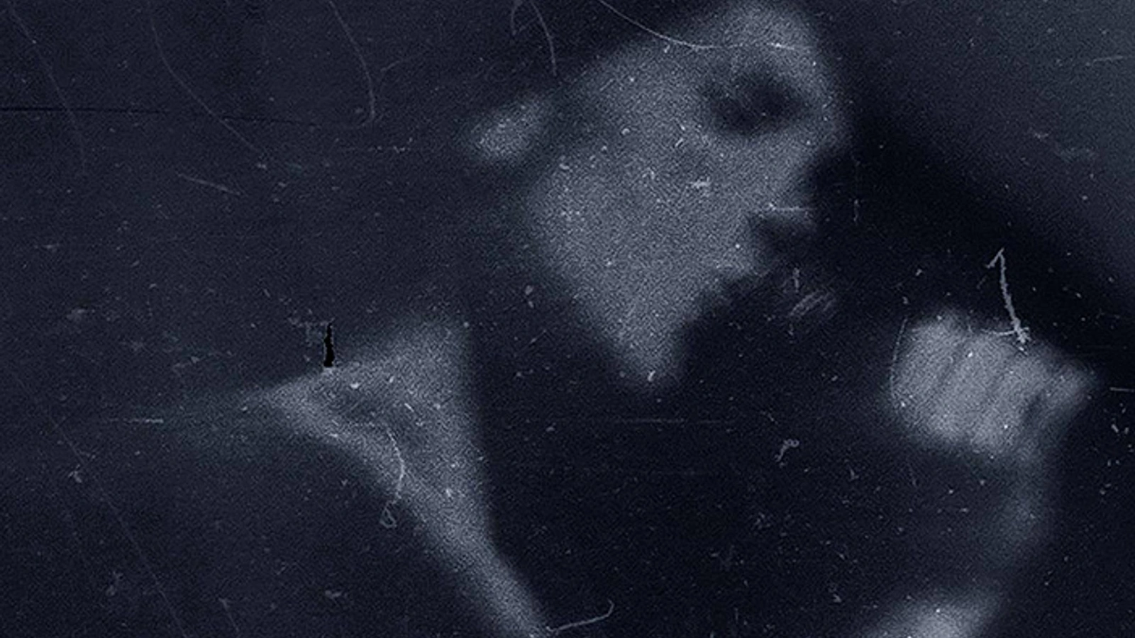 Gabrielė Labanauskaitė-Diena of AVaspo singing into a microphone in a blurred blue-toned archival photograph.