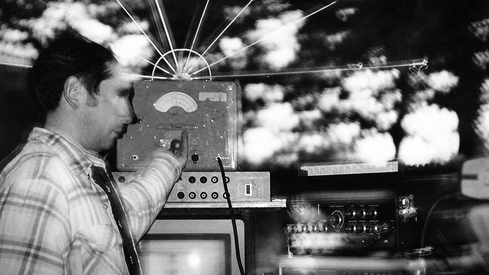 Bobby Bird in a layered double-exposure photograph with electronic equipment.