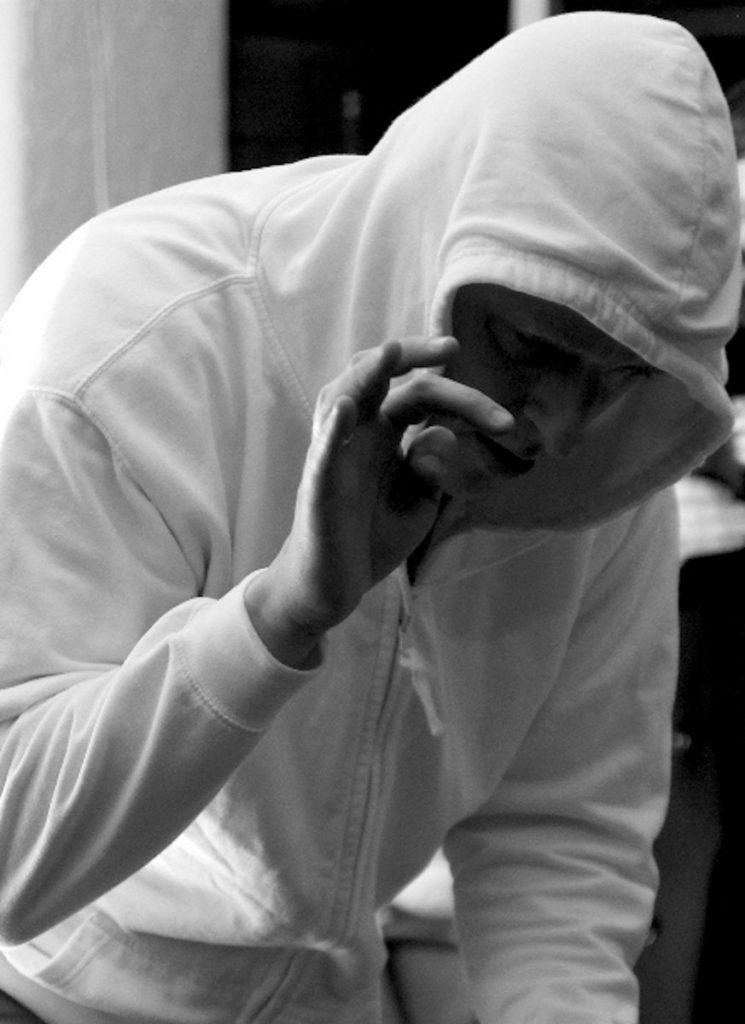 Justin K. Broadrick in a light hooded sweatshirt.