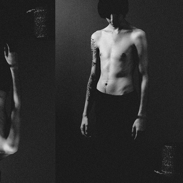 S13 (Justinas Mikulskis) in an experimental, grainy black-and-white portrait.