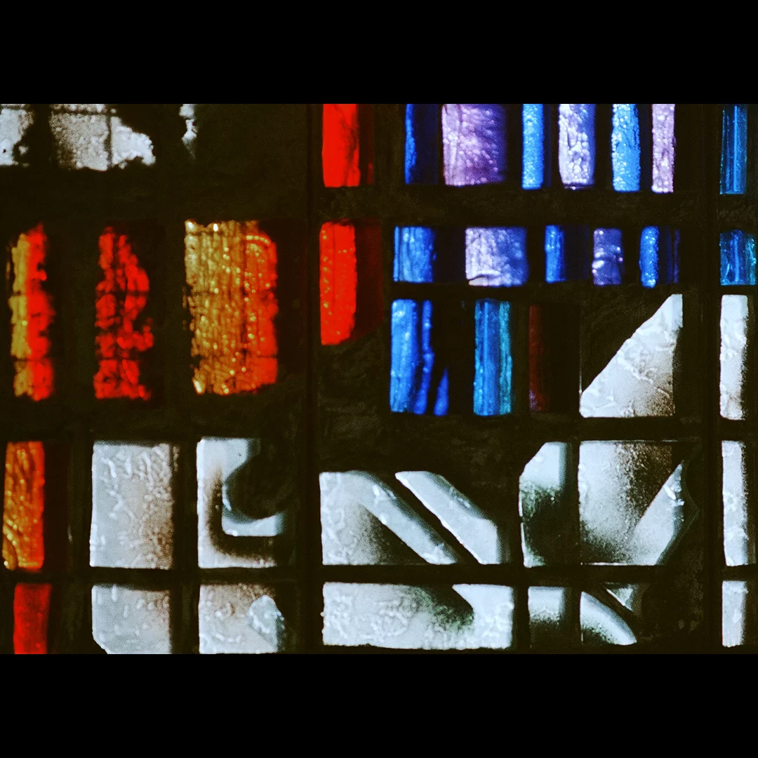 Coloured light and shadows through a stained-glass window