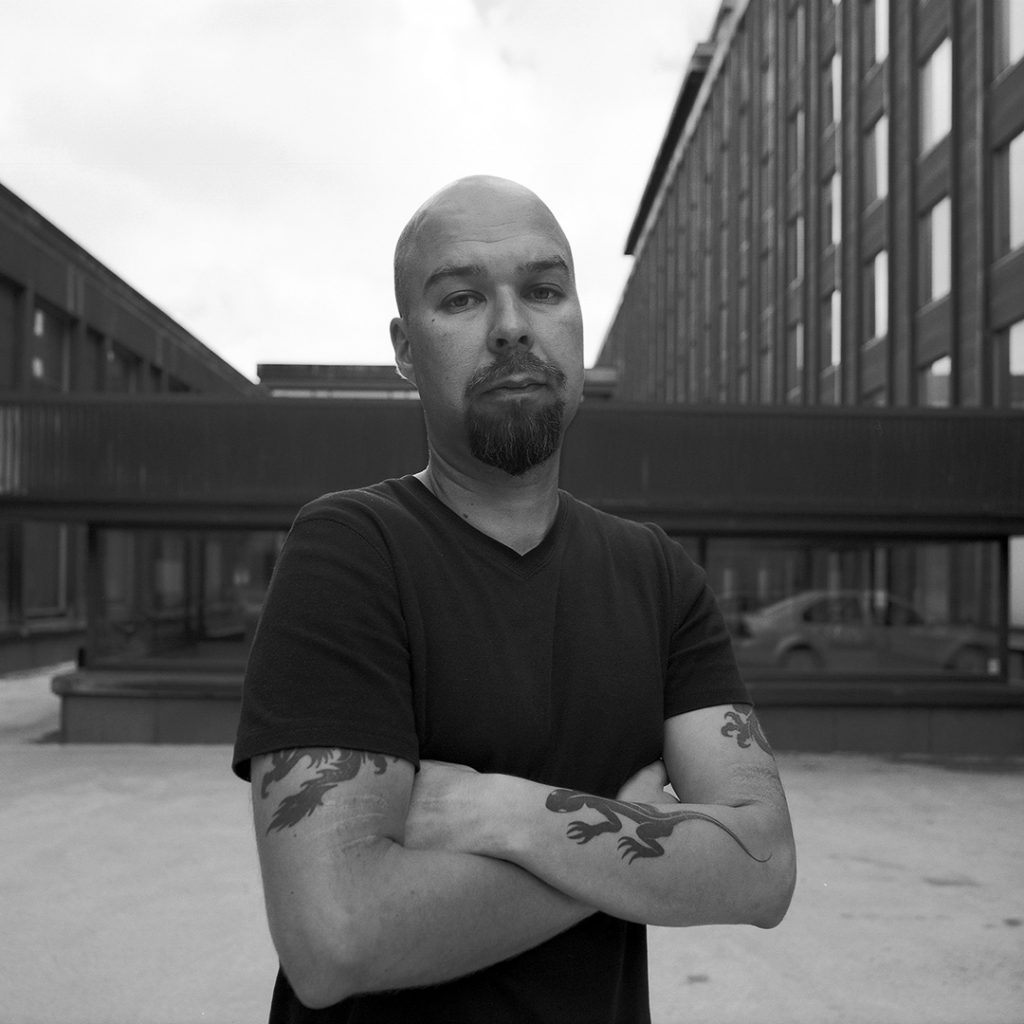 Mika Vainio with his arms folded, photographed by Tommi Grönlund