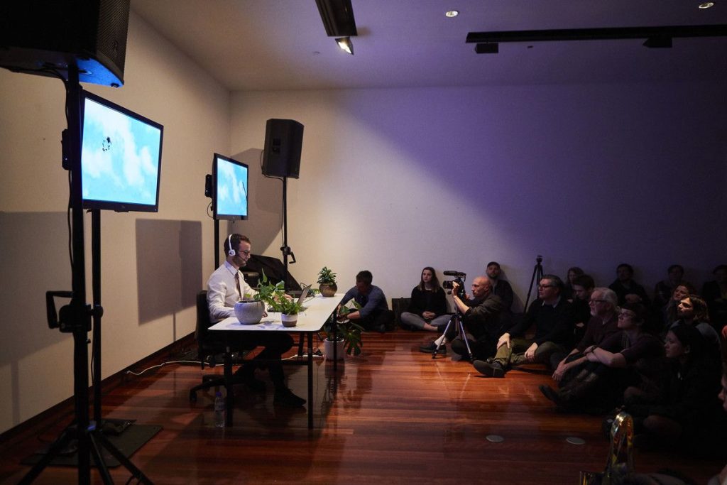 Sam Kidel performing Customer Service Agent in front of an audience