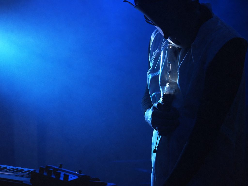 Arma Agharta performing under blue stage lights