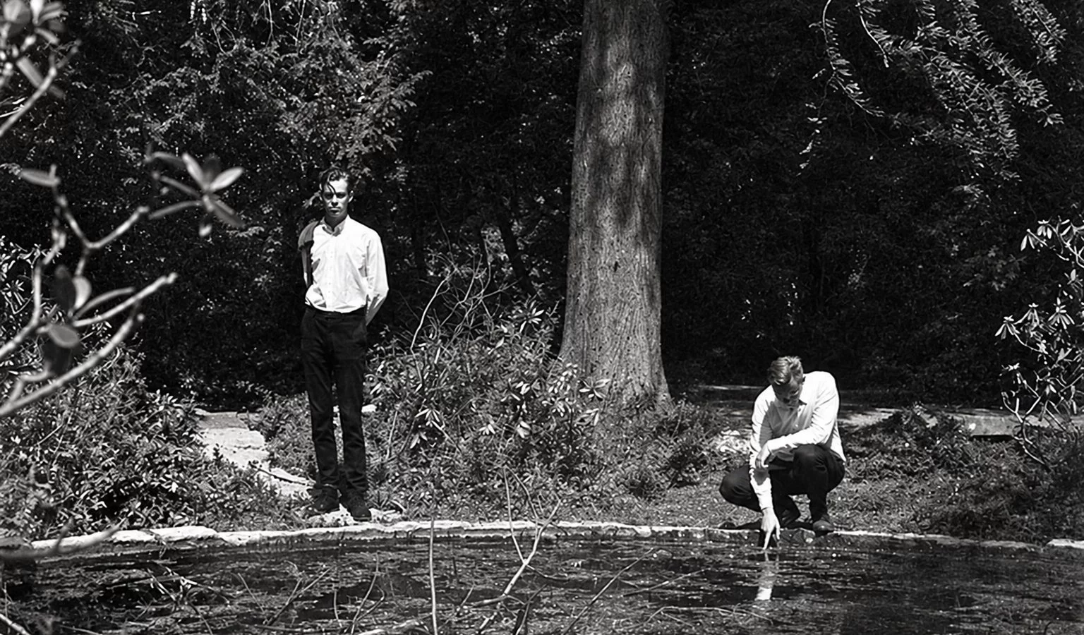 Christian Stadsgaard and Loke Rahbek beside a pond