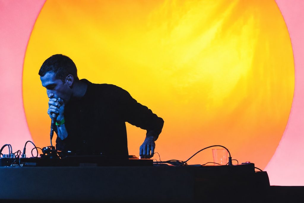 Alessio Natalizia performing as Not Waving under colourful stage lights