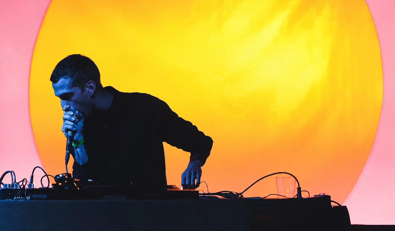 Alessio Natalizia performing as Not Waving under colourful stage lights