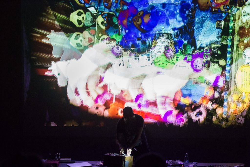 Ian Hawgood performing in front of a large projection