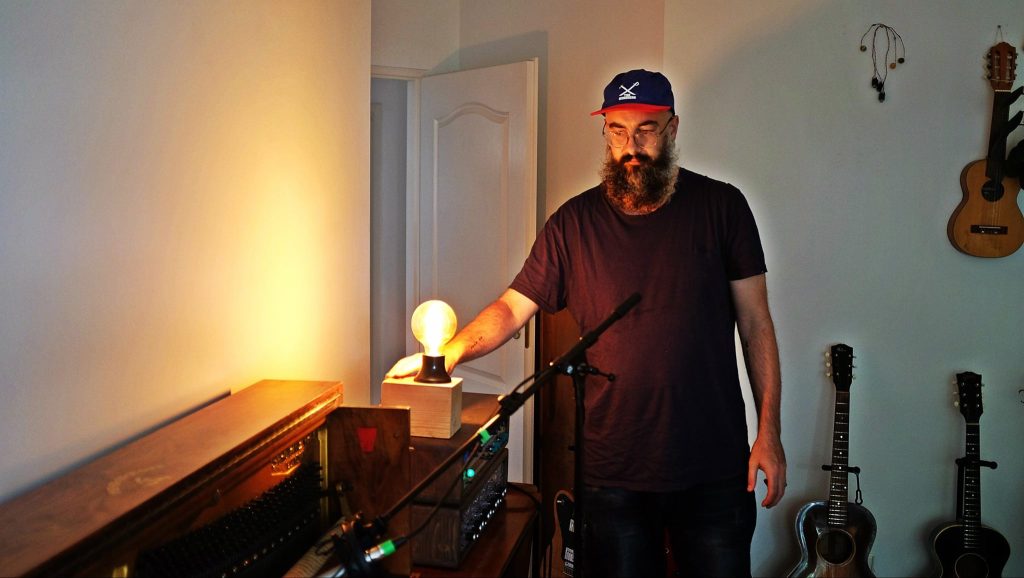 Ian Hawgood standing among studio instruments