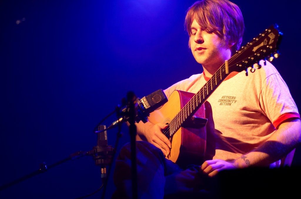 James Blackshaw playing an acoustic guitar on stage
