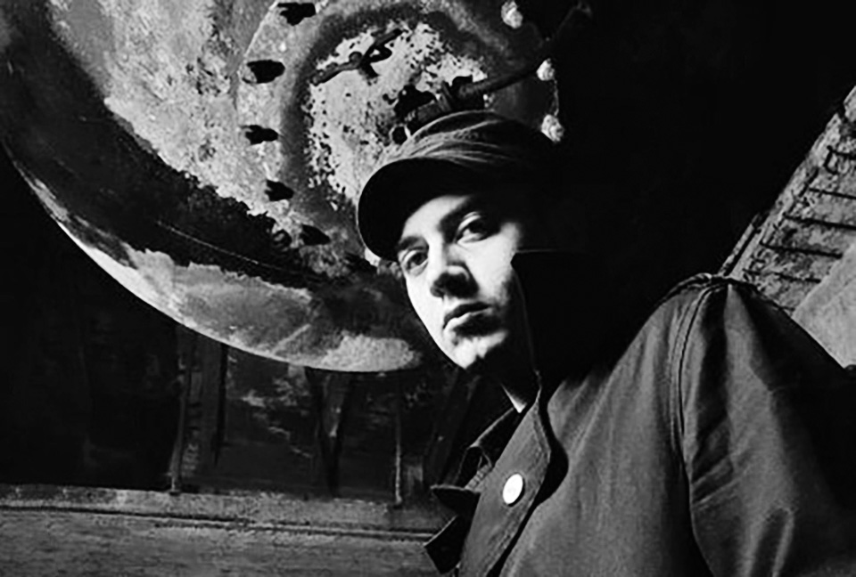 Alessandro Adriani beneath a large hanging light.