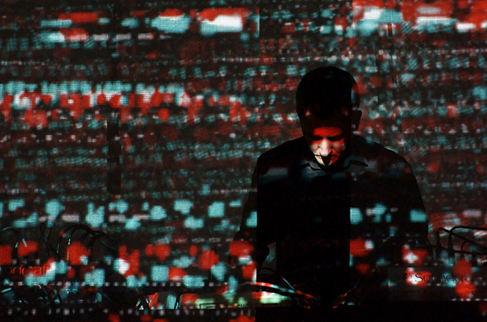 Dmytro Fedorenko performing against a projection.